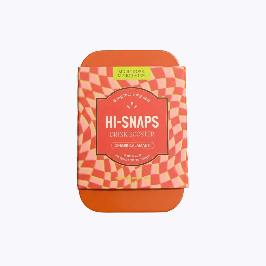 A square tin of Hi-Snaps Drink Booster ginger calamansi flavor, featuring an orange and white checkered pattern with a coral-red center label, set against a solid orange background with soft leaf shadows.